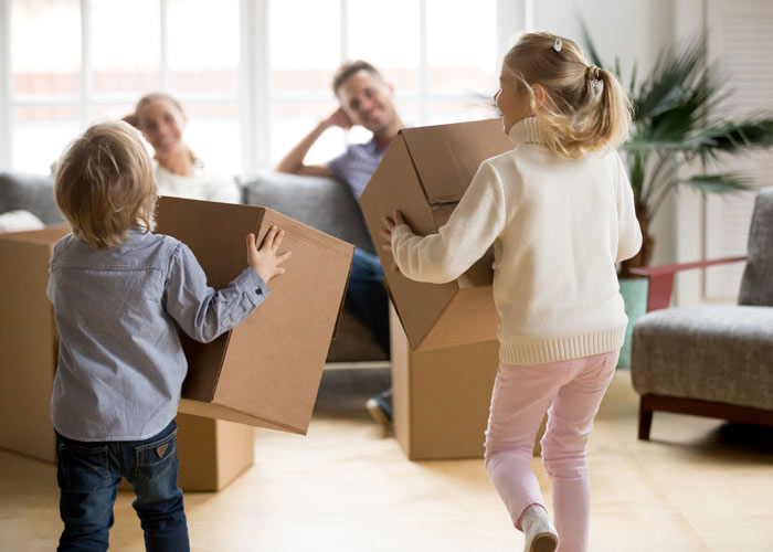rear-view-kids-playing-with-boxes-moving-day